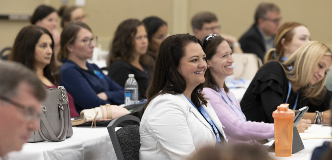 Woman smiling at Annual Session